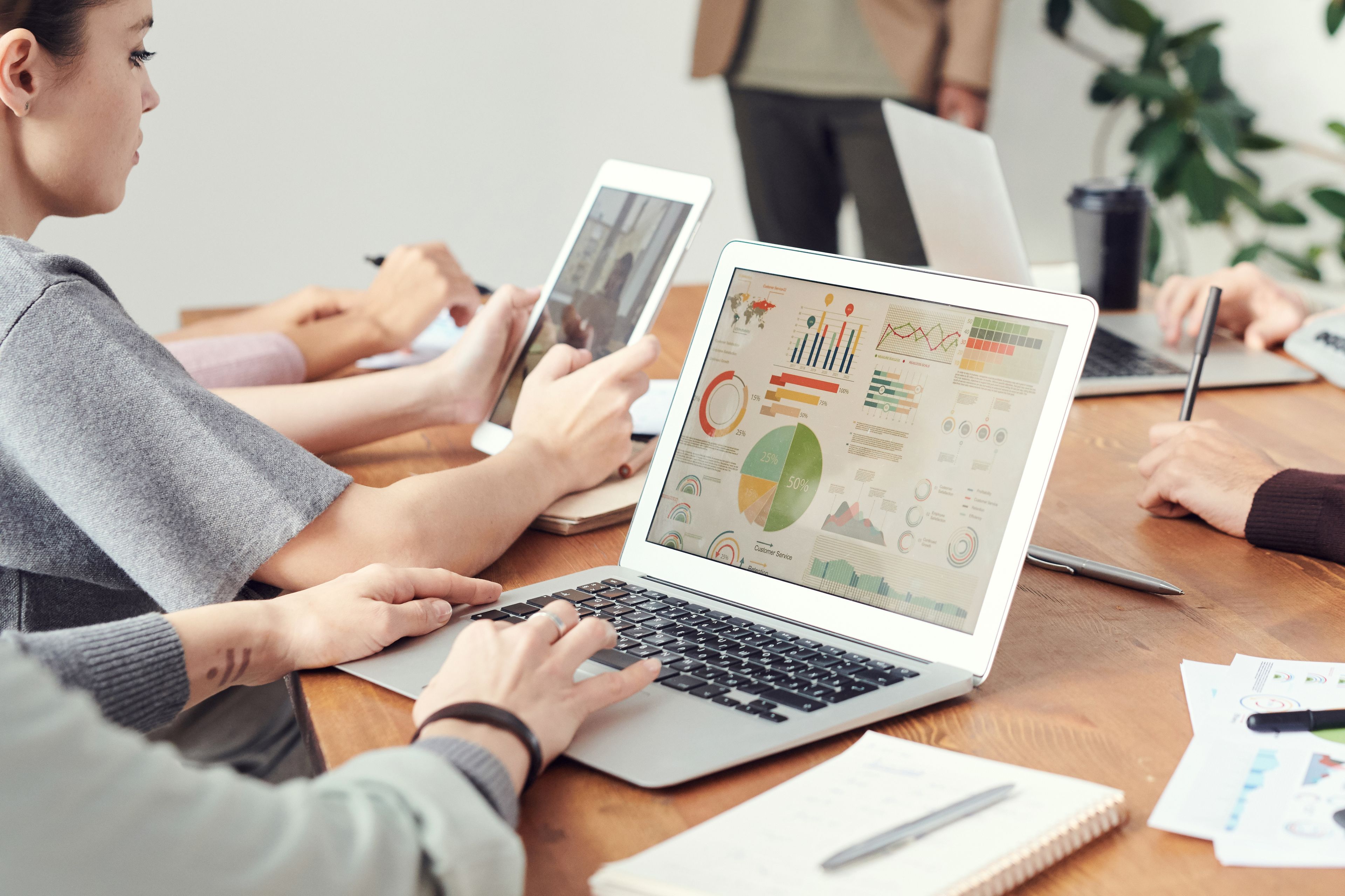 Marketing team reviewing digital campaign plans on a laptop